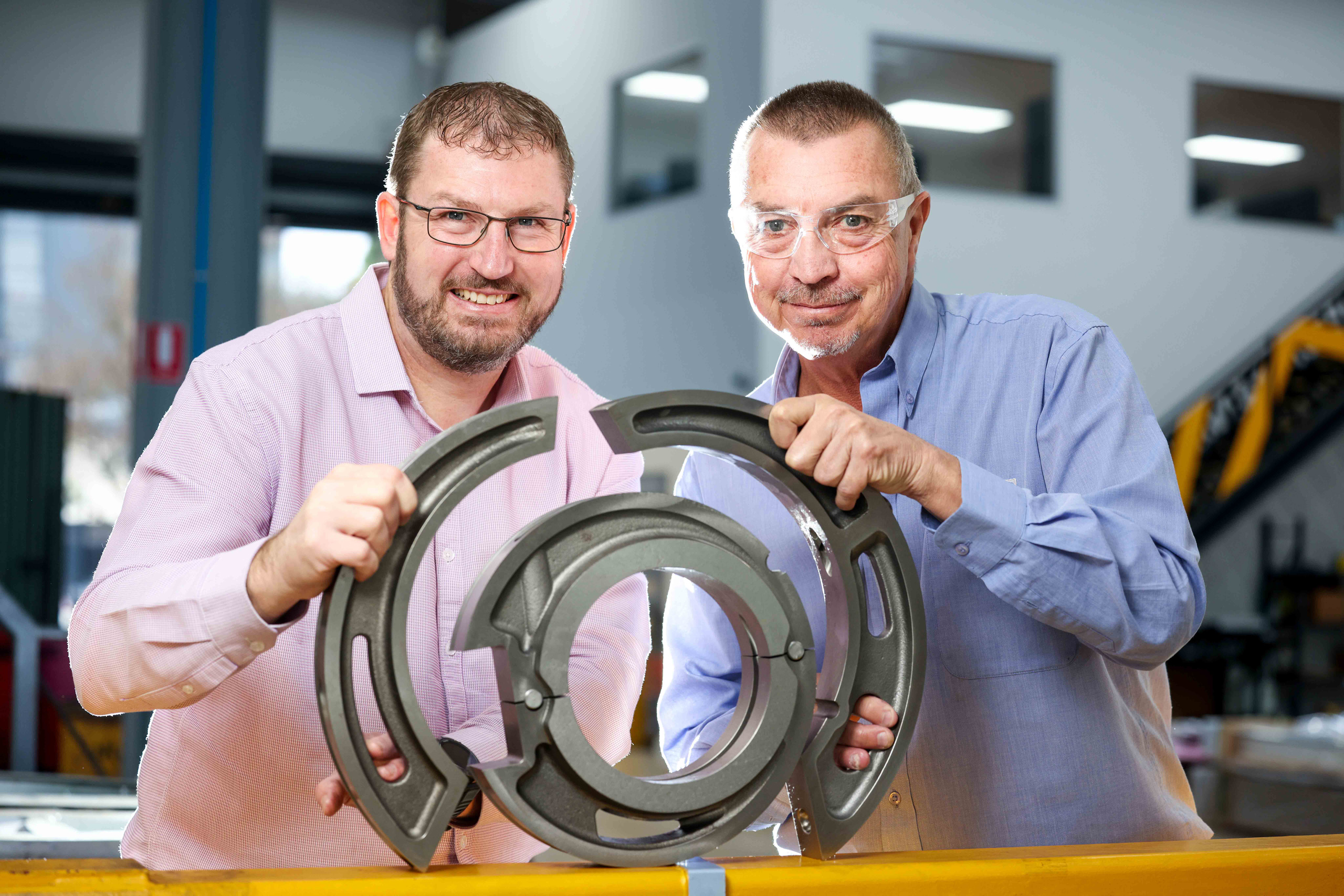 Axiom Precision Manufacturing general manager Craig Maynard and ASC subcontracts administrator Tim Bowes